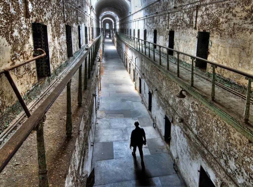 man walking at the halls of the Eastern State Penitentiary