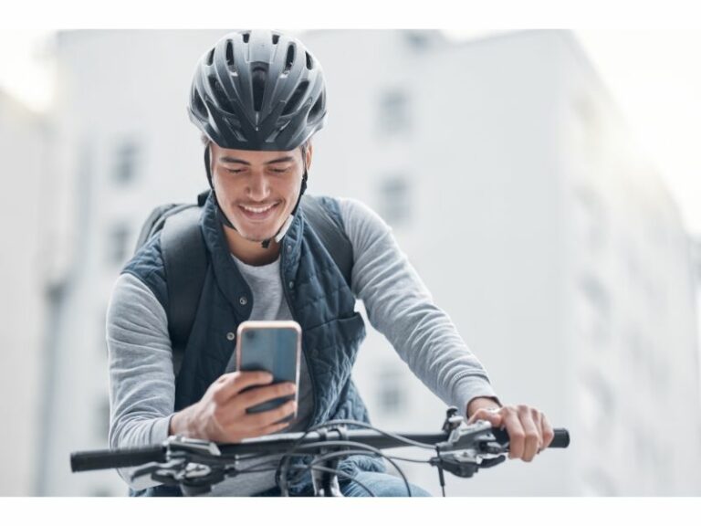 Man with mobile phone traveling by bike