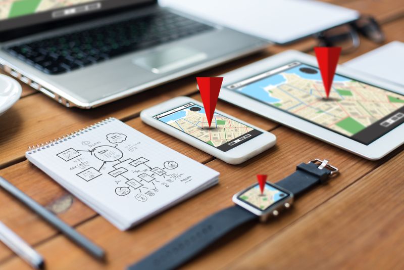 Travel apps with red pins on gadgets