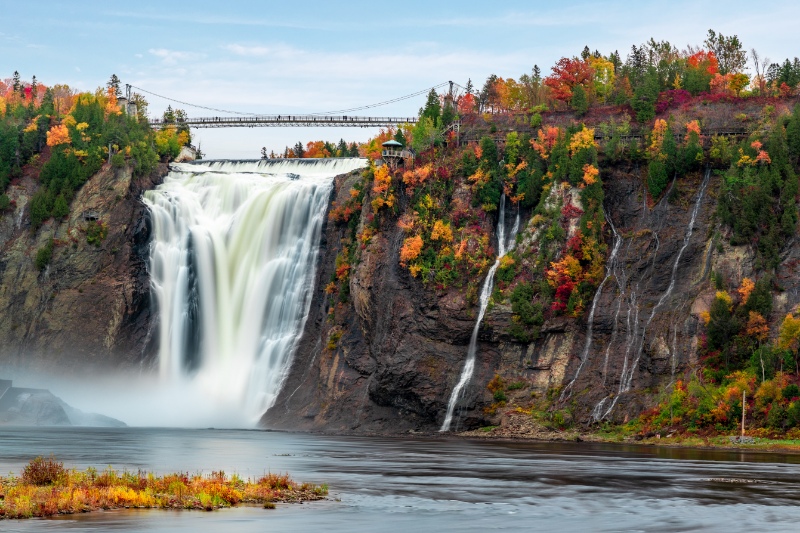 Montmorency Falls and Bridge in autumn with colorful trees 