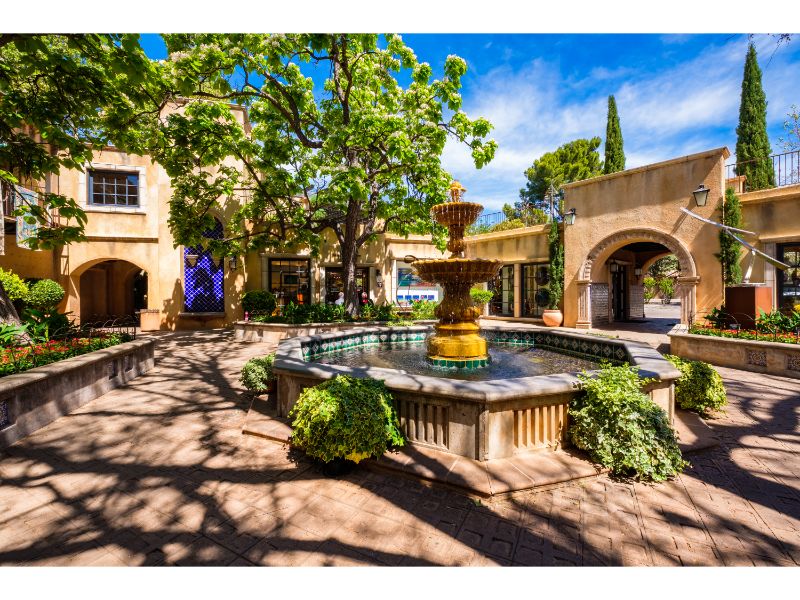 The Tlaquepaque Arts and Crafts Village, with vintage adobe style architecture, is a popular tourist destination filled with retail shops and restaurants.