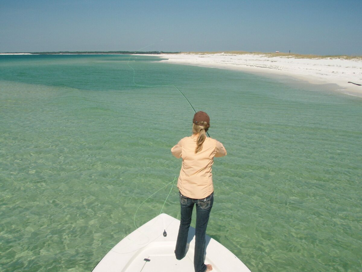 A lady fishing at Gulf Breeze Guide Service