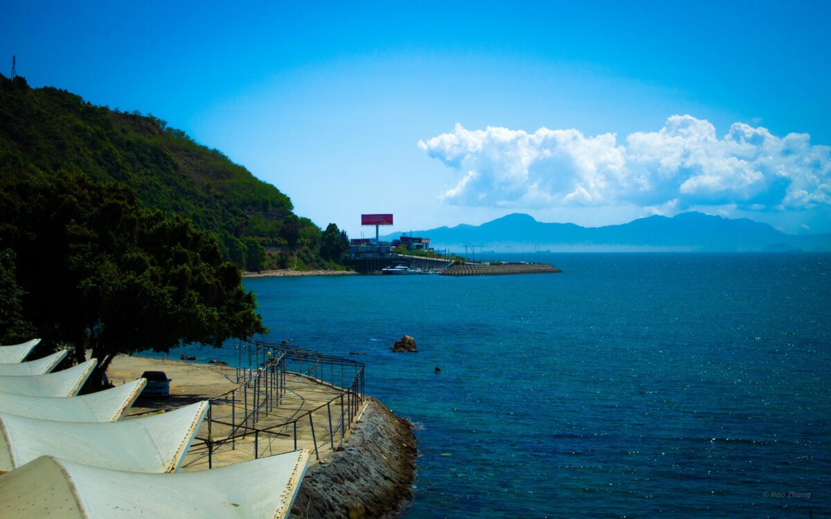 Beautiful view from the shore of the Huizhou Xunliao Bay in China on blue cloudy sky background