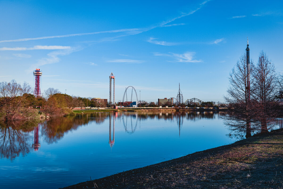 Six Flags over Texas reflecting off a lake | Things to do in Arlington