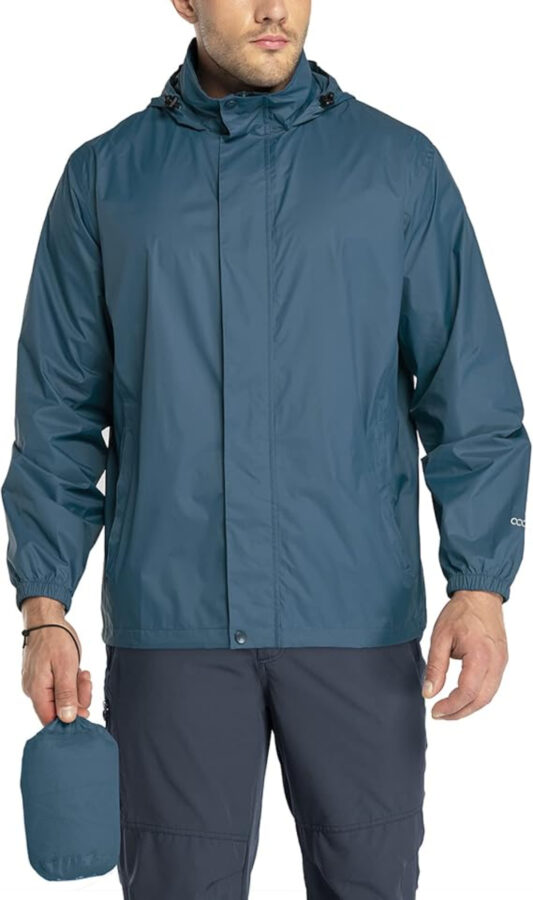 Lightweight packable rain jacket designed for travel, featuring a hood and adjustable cuffs for a snug fit