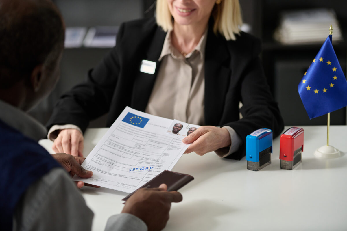 Woman handing over an approved visa application form