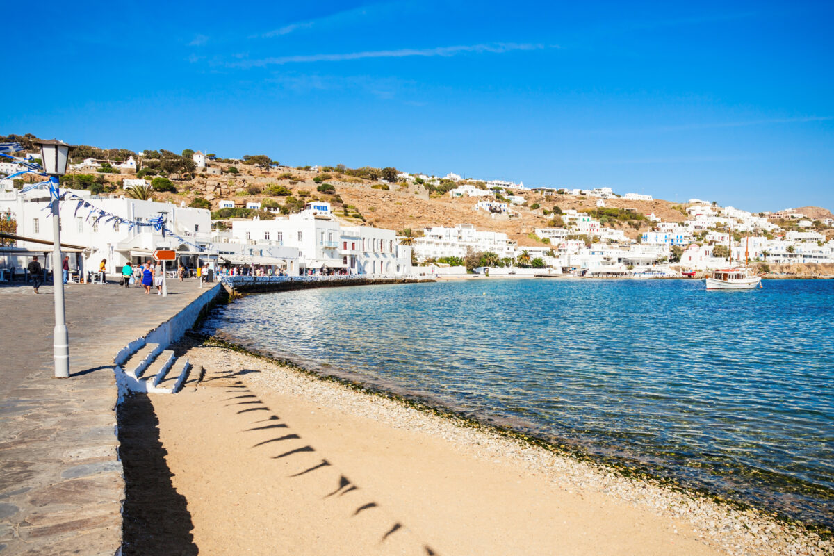 Crystal-clear turquoise waters and golden sand at Paradise Beach Mykonos, one of Greece's most popular beach destinations with vibrant beach clubs and water sports