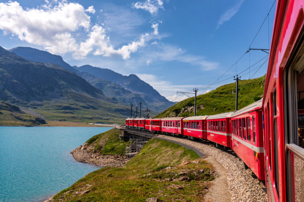 Bernina Express passing by the Lago Bianco Lake in Switzerland