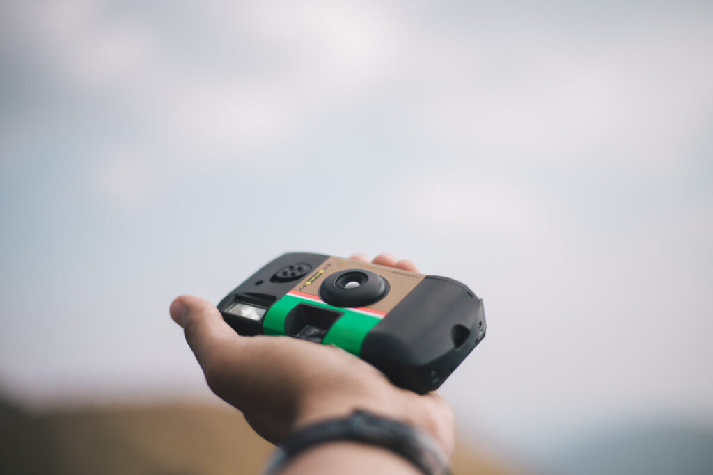 Hand holding a disposable film camera
