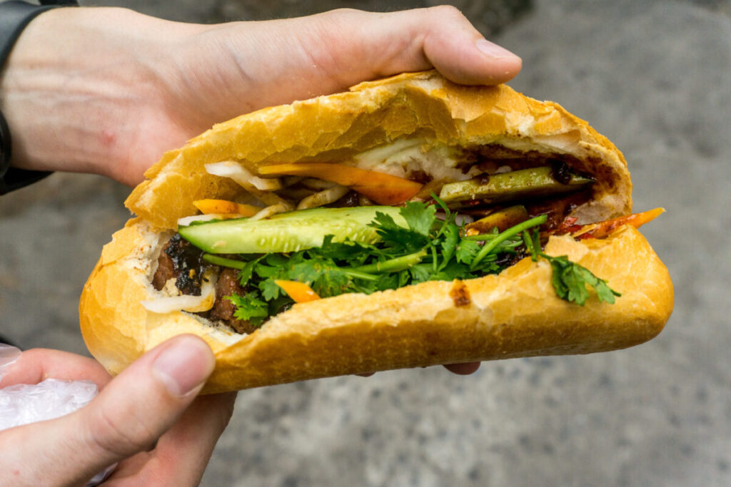 Close-up of a hand holding a Bánh Mì  in Ho Chi Minh City, Vietnam