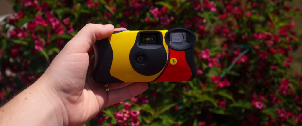 Hand holding a disposable camera