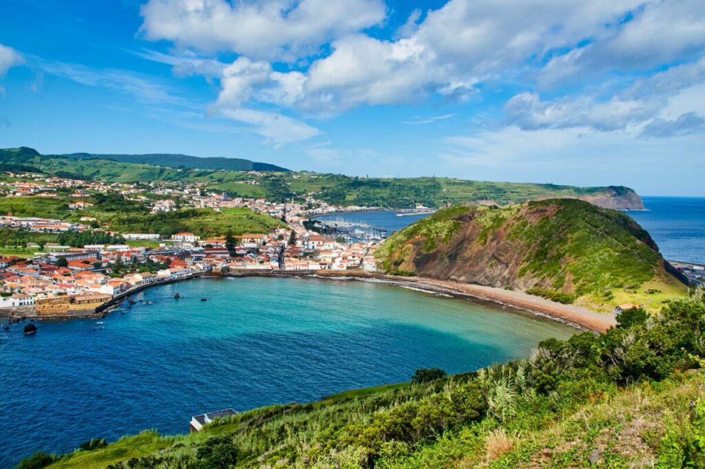 Horta city on Faial island, Azores, surrounded by the ocean and rolling hills, showcasing its natural beauty