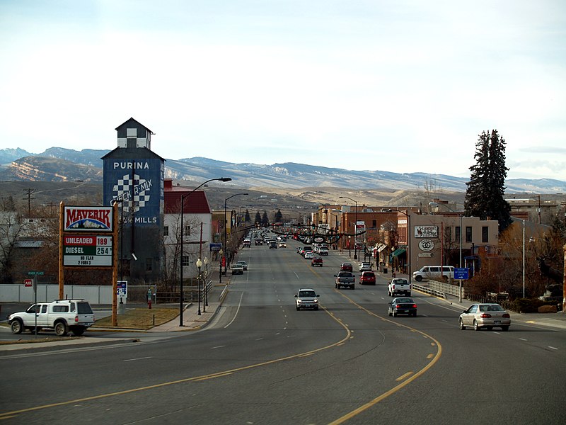 Lander, Wyoming, nestled amid the Wind River Range, featuring a charming downtown with historic buildings and a scenic view of the Popo Agie River winding through the town.