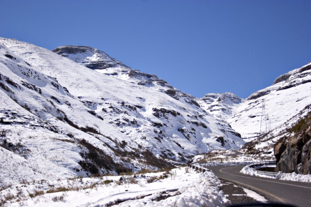 Road surrounded with snow covered mountains and landscape in Lesotho, Southern Africa