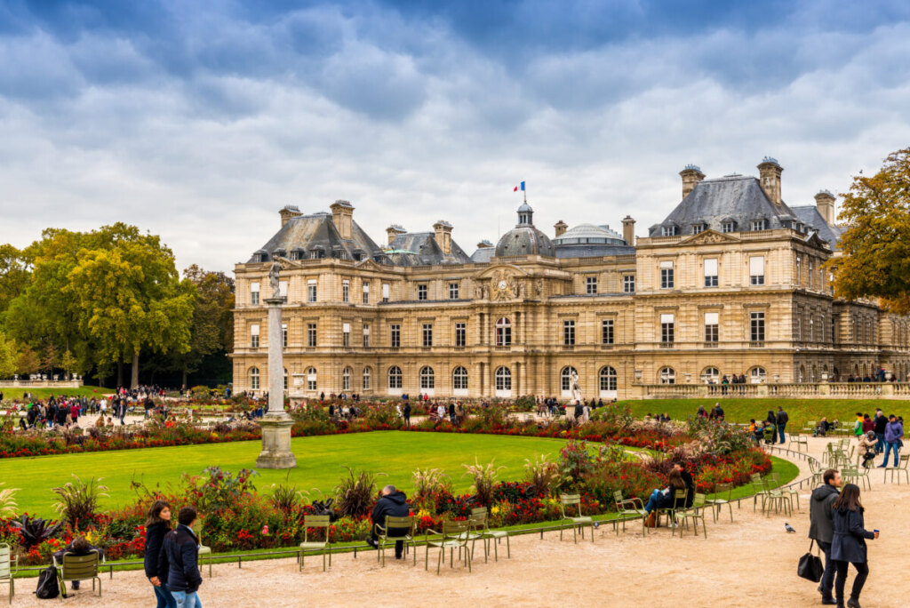 Tourists exploring and walking around the Luxembourg Palace and Luxembourg Garden in Paris, France