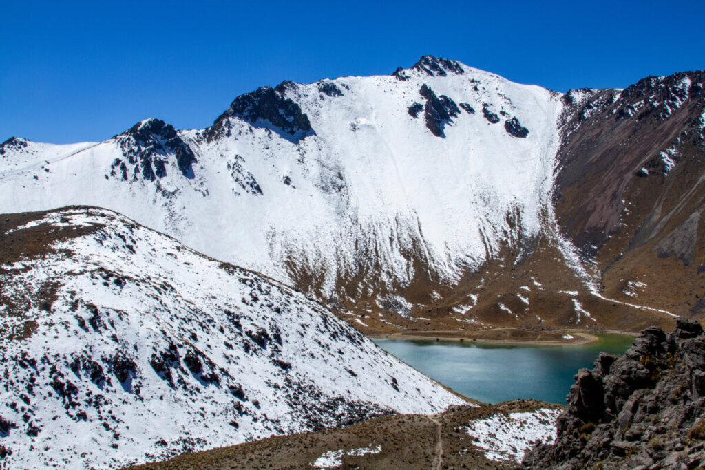 Lagoon and the snow covered mountain range of Nevado de Toluca in Mexico