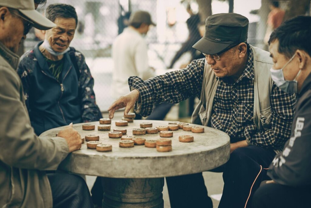 Group of old Chinese folks playing a board game