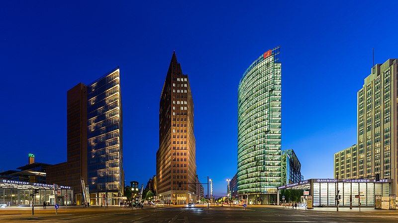 Potsdamer Platz in Berlin, Germany, a bustling urban square with modern skyscrapers, a vibrant cityscape, and people enjoying outdoor cafes.