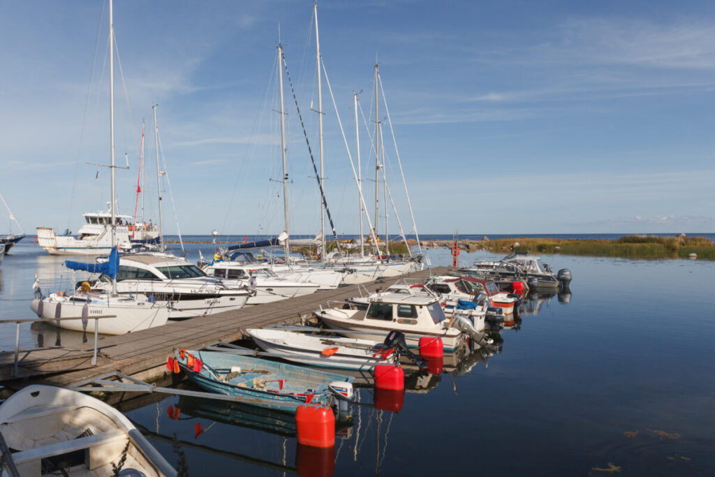 Yachts docked at a pier in Prangli, Estonia, under a clear blue sky on a sunny day