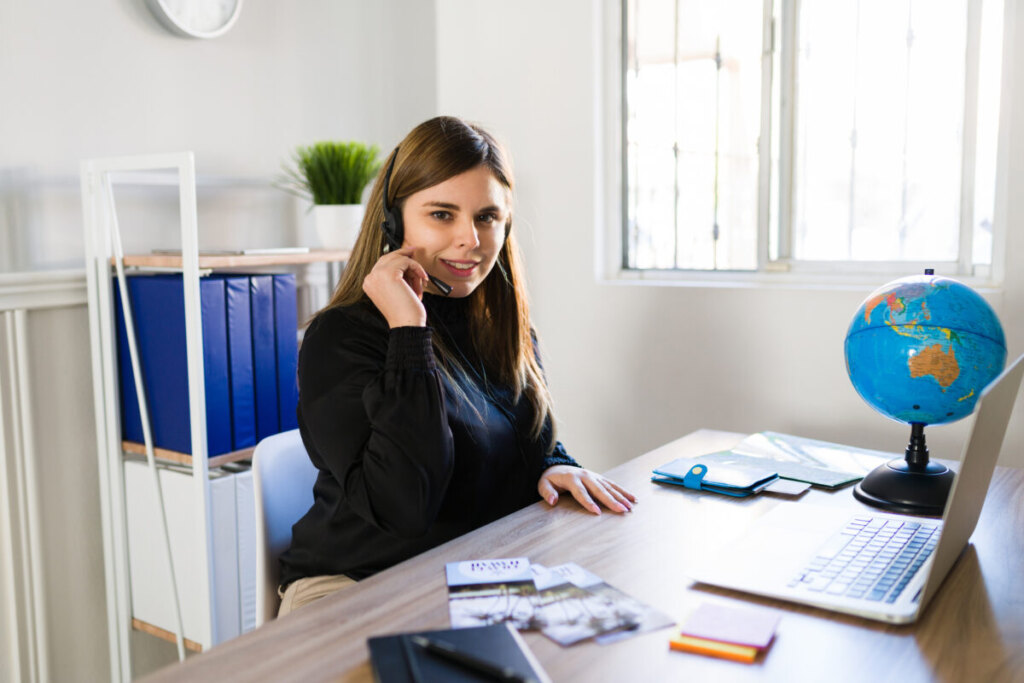 Female travel agent working remotely and talking to a customer