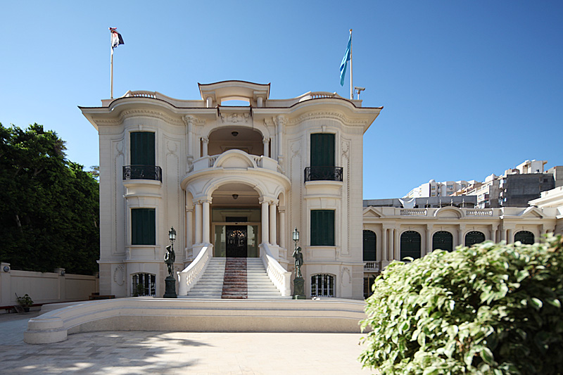 The Royal Jewelry Museum, an opulent palace showcasing a dazzling collection of ornate jewelry and artifacts against a backdrop of grandiose architecture and lush gardens.
