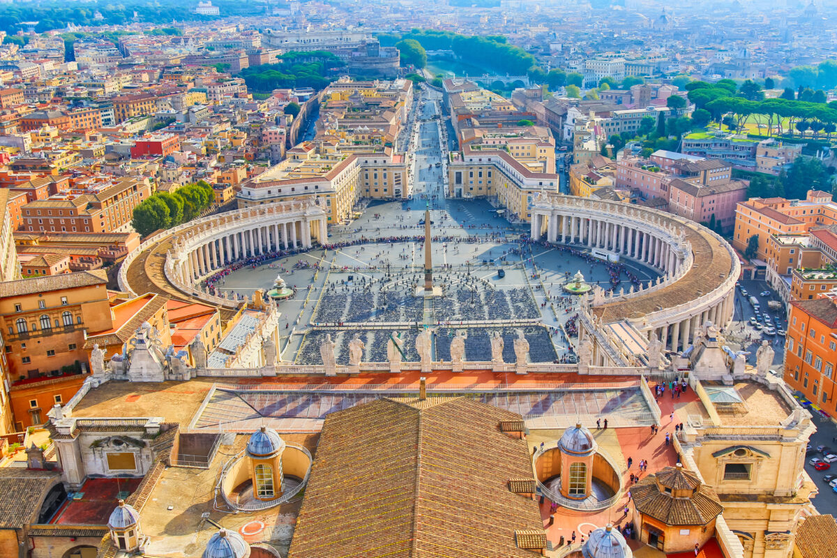 Famous Saint Peter's Square in Vatican and aerial view of the Rome city during sunny day.