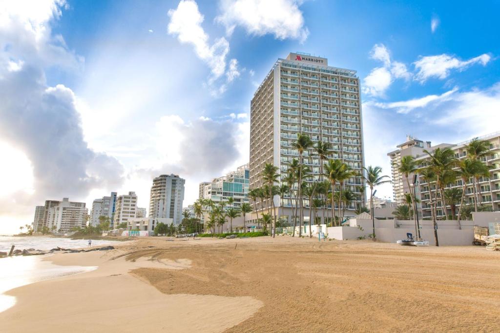 Oceanfront view of San Juan Marriott Resort and Stellaris Casino with palm trees and beach access