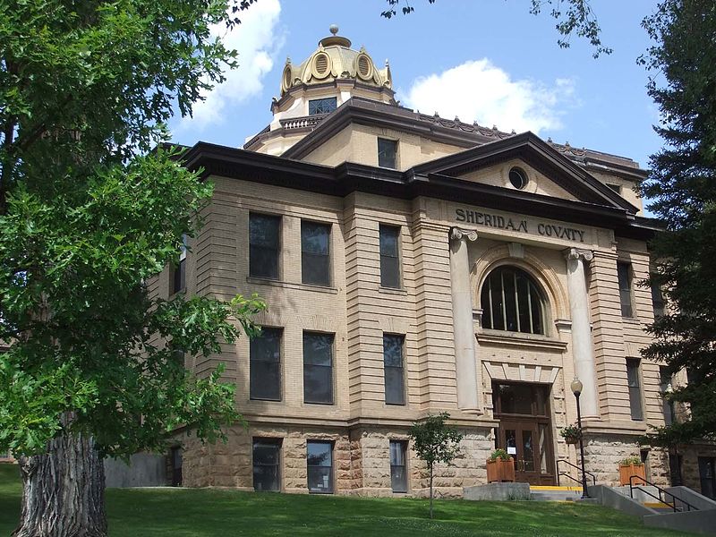 Sheridan, Wyoming, a picturesque town nestled against the Bighorn Mountains, known for its historic Main Street with brick buildings, and the scenic beauty of the nearby Bighorn National Forest.