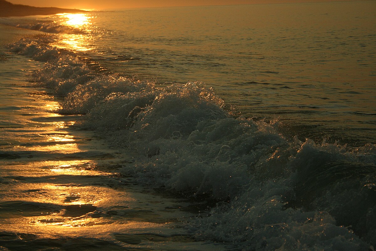 Golden sunrise over surf at South Beach Martha's Vineyard