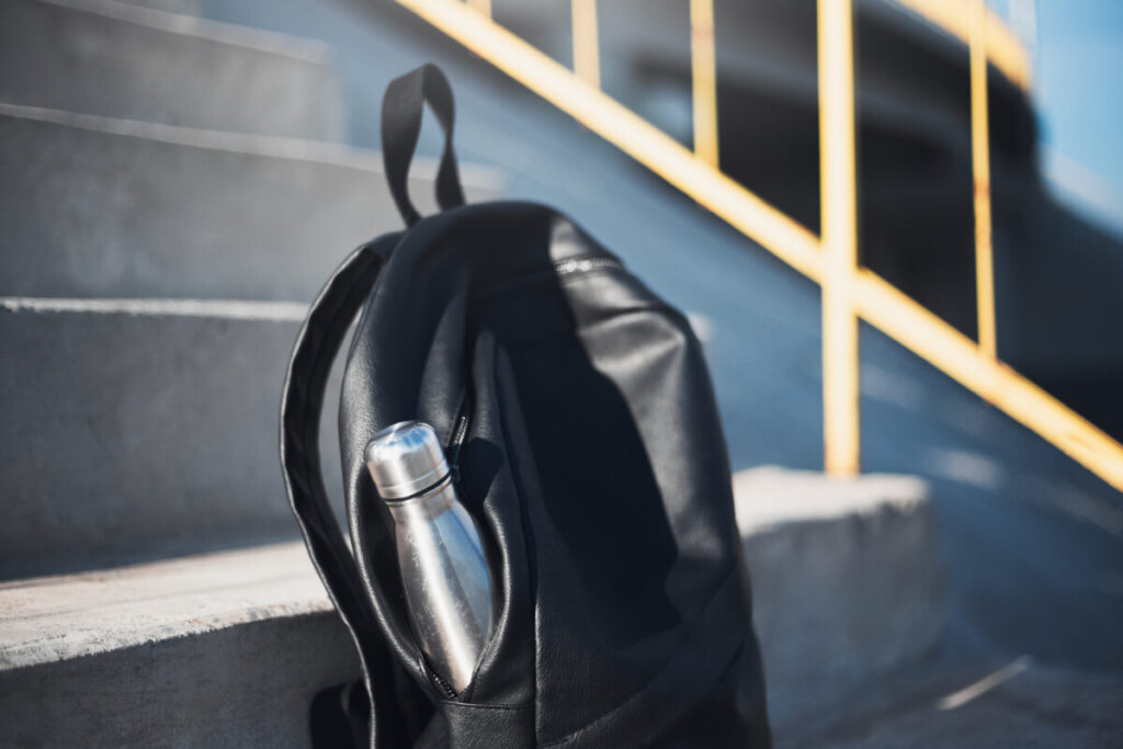 Close-up of a bag with a reusable steel thermo water bottle