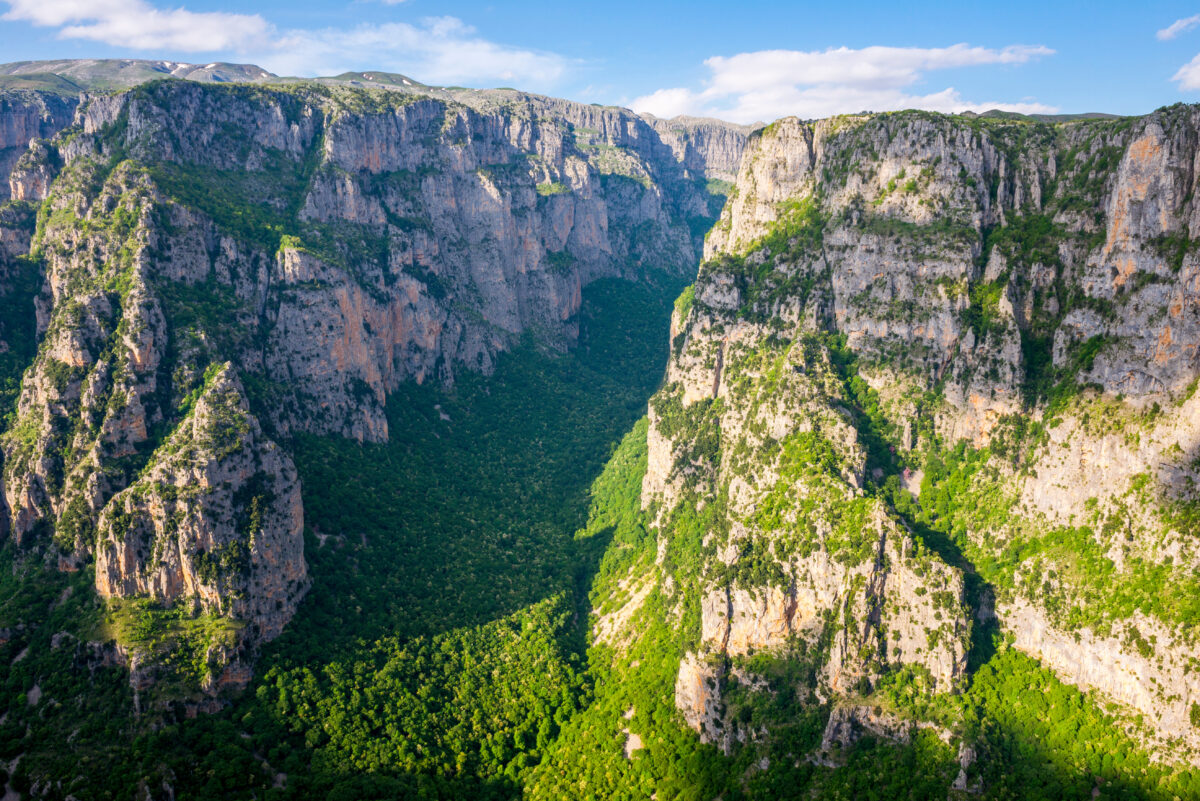 Panoramic aerial view of Vikos Gorge in Zagori, Northern Greece showing dramatic limestone cliffs and the Voidomatis River