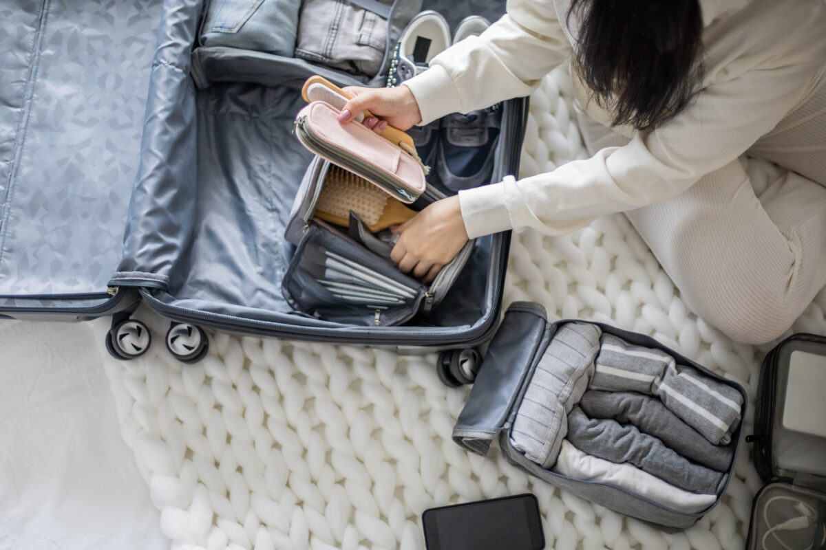 Suitcase with strategic empty space and packable bag for souvenirs and shopping